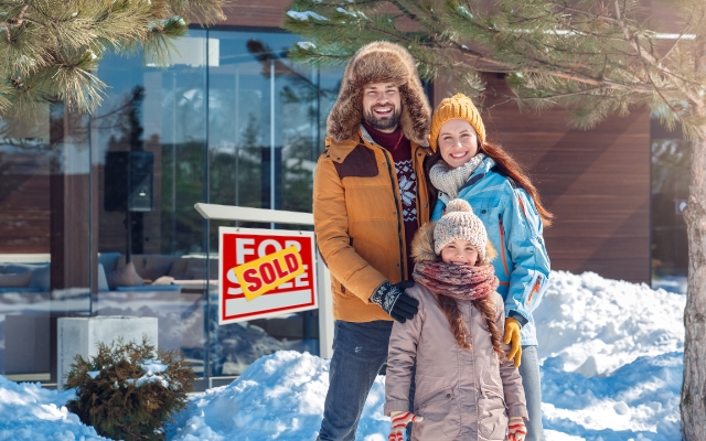 Family standing outside of their new home