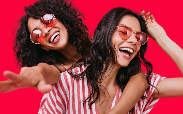 Best friends wearing heart glasses and having fun