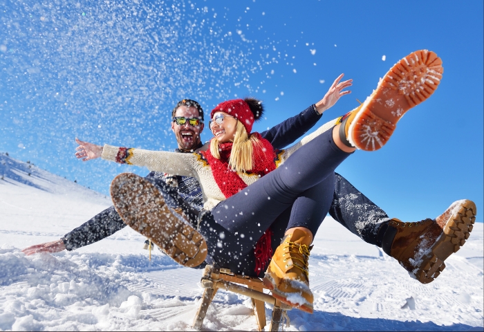 a couple sledding on a winter day