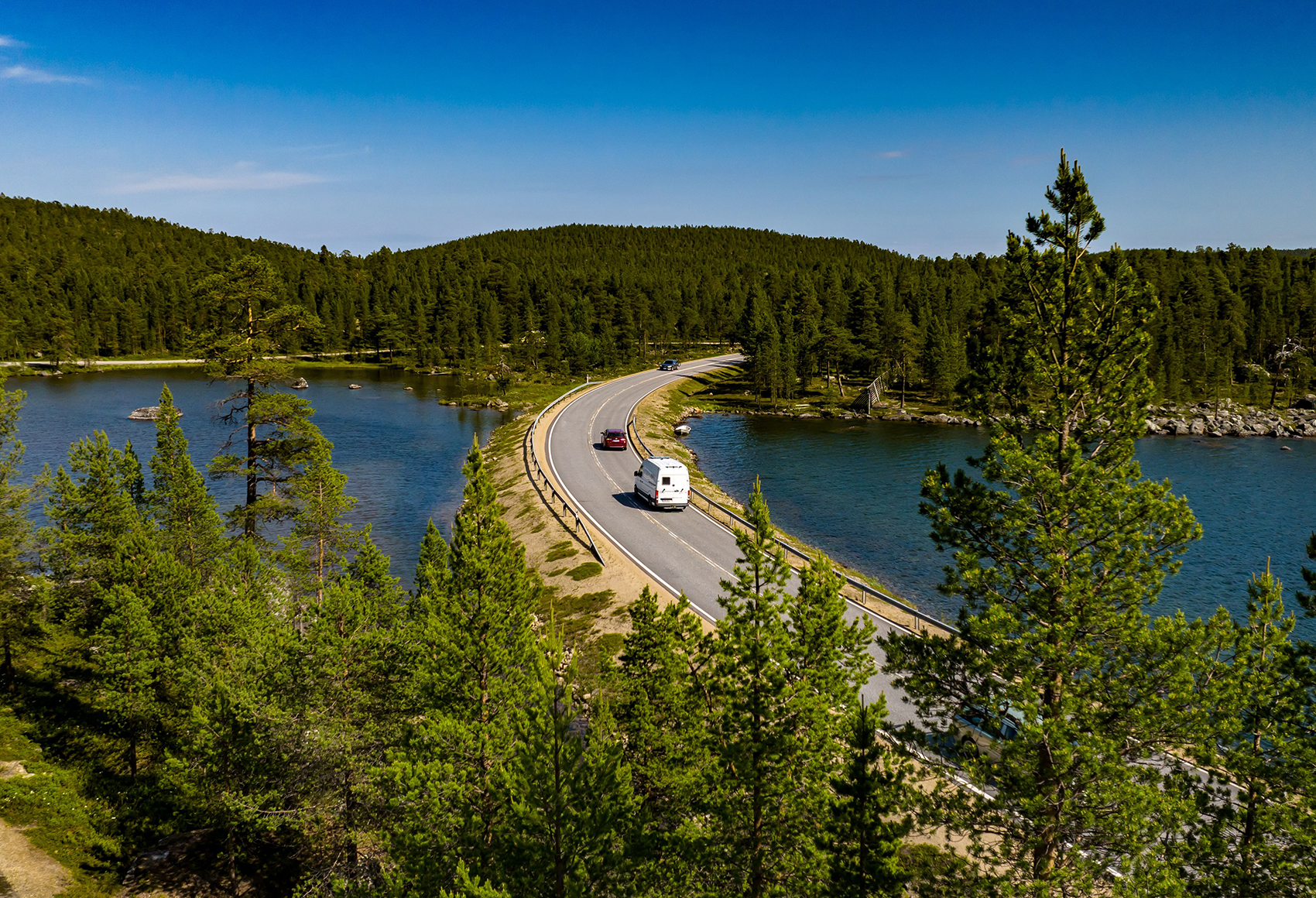 aerial view of a road going between two bodies of water
