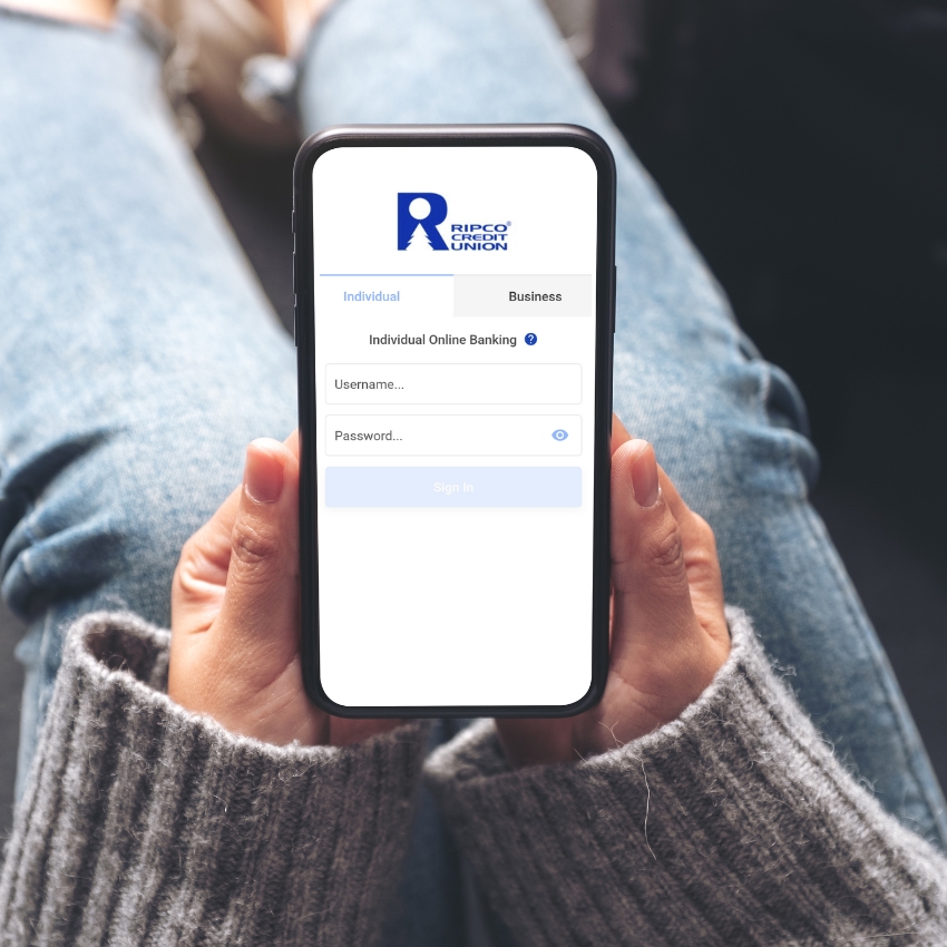 A person holding a cell phone with our mobile app